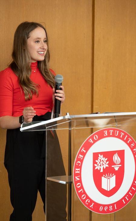 Photo of Ava Kelly speaking at podium