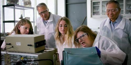 Photo of students and faculty in physics lab