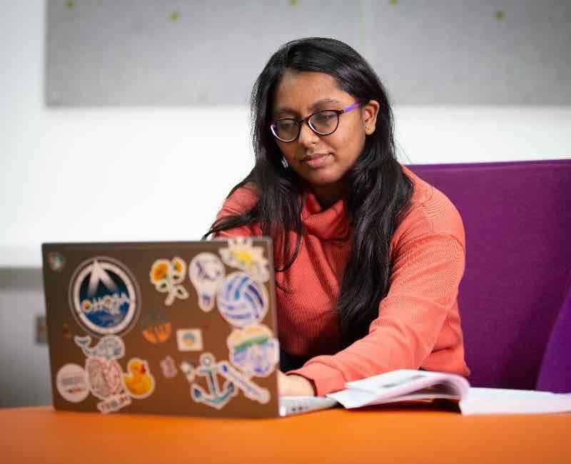 AI student working on a laptop computer